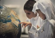 Children studying the globe Click to view high resolution version